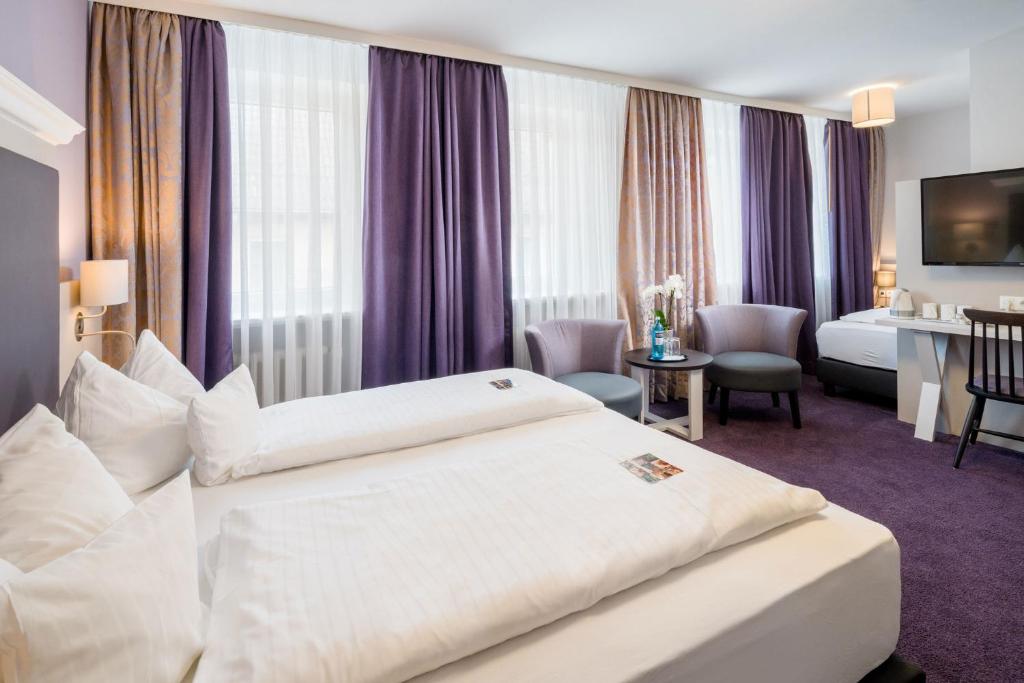 Postel nebo postele na pokoji v ubytování Flair Hotel Rieckmann
