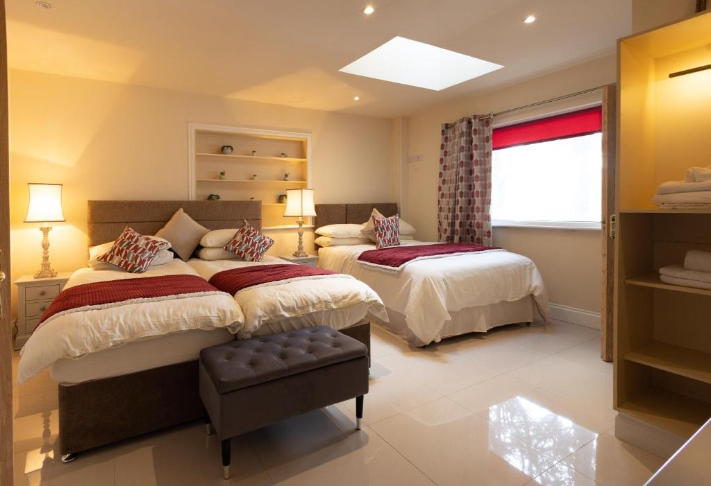 a bedroom with two beds and a window at The Merry Monk in Ballina