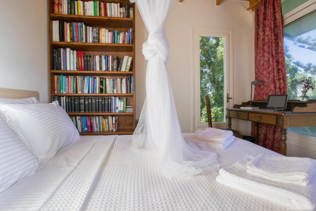 a bedroom with a bed with a wedding veil on it at Villa Orion - Peaceful Retreat Home West of Chania in Kipárissos