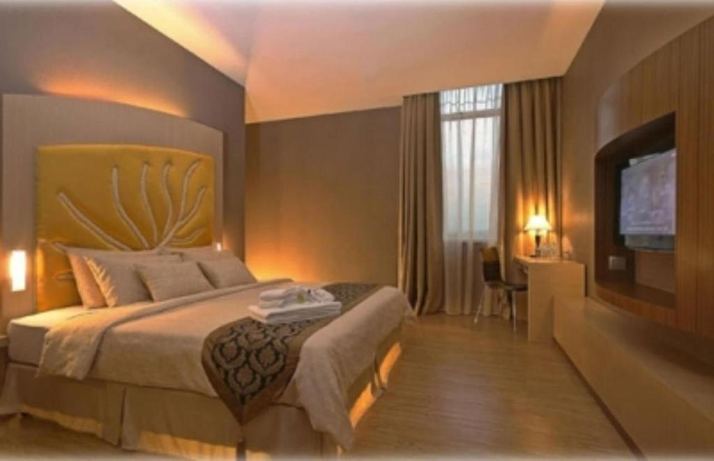 Postel nebo postele na pokoji v ubytování Courtyard Hotel 1Borneo