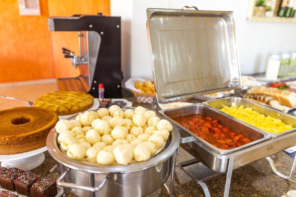 a buffet with many different types of food on a counter at Pousada Recanto das Flores in Governador Celso Ramos