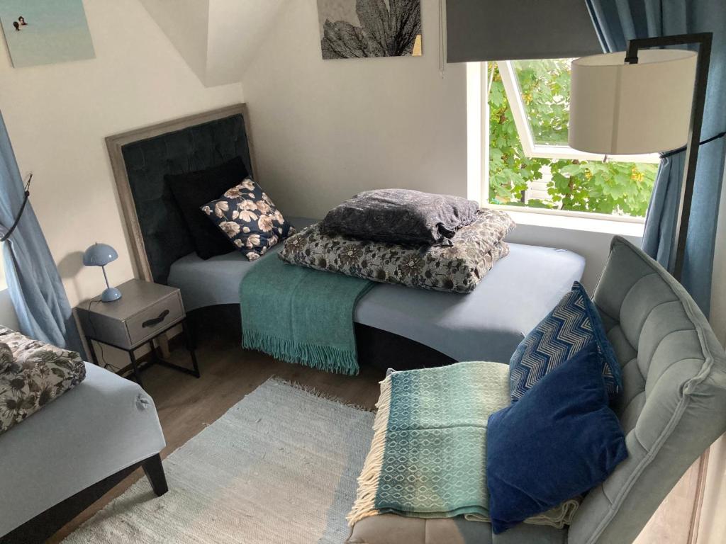 a living room with two beds and a couch at Downtown Historical House with Renovated apartments in Ålesund