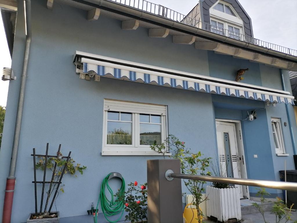 a blue house with a window and a balcony at Desire in Heidelberg