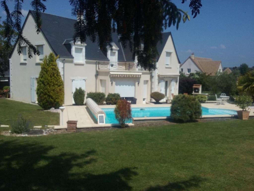 une grande maison blanche avec une piscine dans l'établissement Le Clos de Mosny, à Amboise