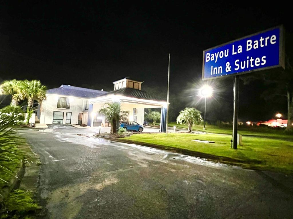 a street sign in front of a house at night at Bayou Inn & Suites in Bayou La Batre