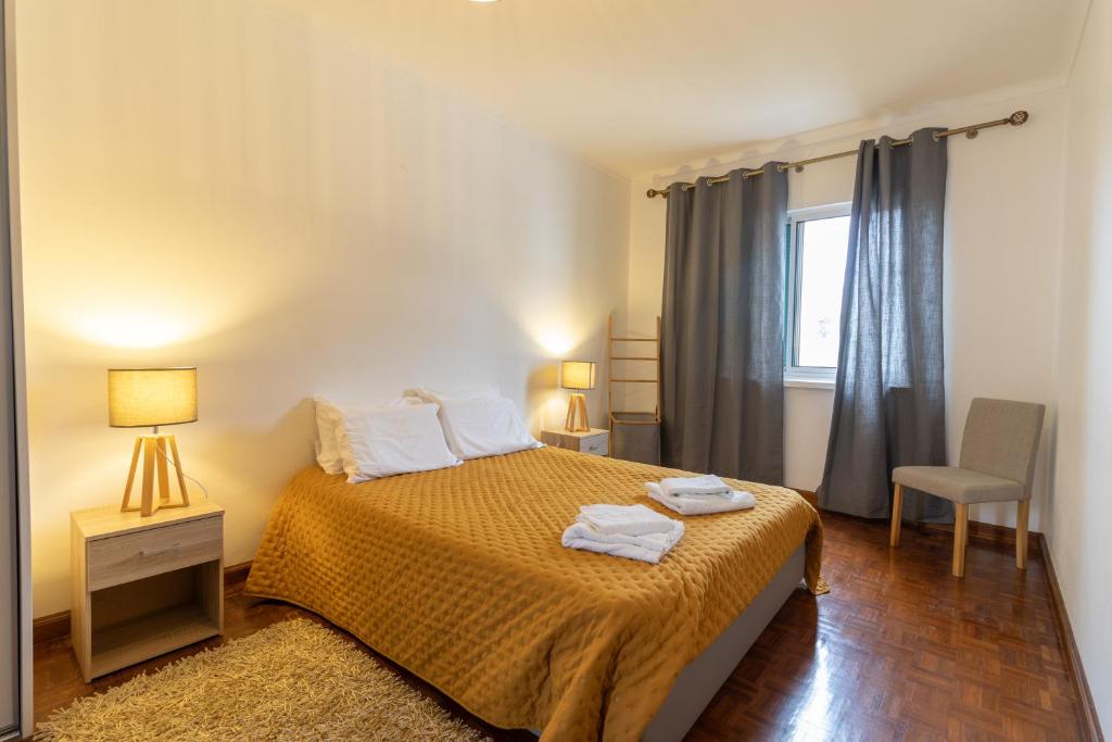 ポンタ・デルガダにあるCasa da Margaridaのベッドルーム1室(ベッド1台、タオル2枚付)