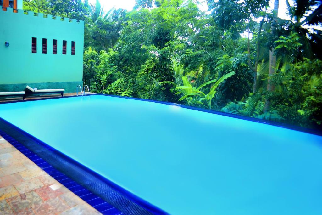 a swimming pool with a view of the jungle at Tropical Retreat in Unawatuna