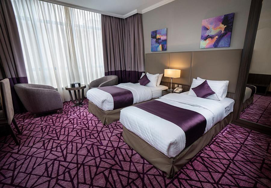 Postel nebo postele na pokoji v ubytování Aquila ALdiafah Hotel