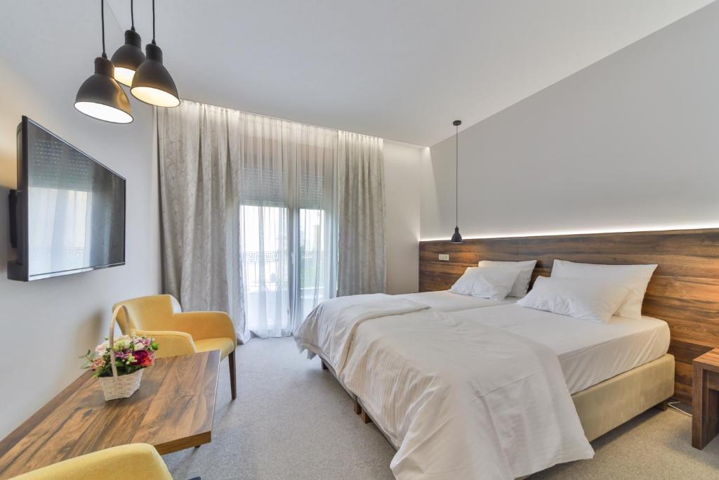 Postel nebo postele na pokoji v ubytování Hotel Vladimir