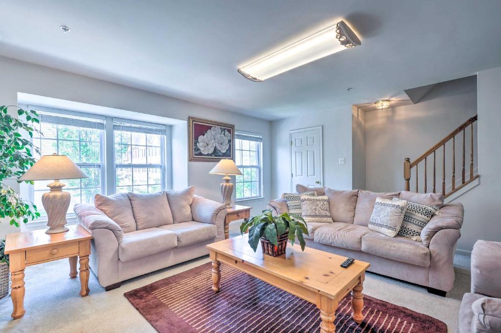 a living room with two couches and a table at Elkridge Townhome about 15 Mi to Dtwn Baltimore! in Elkridge
