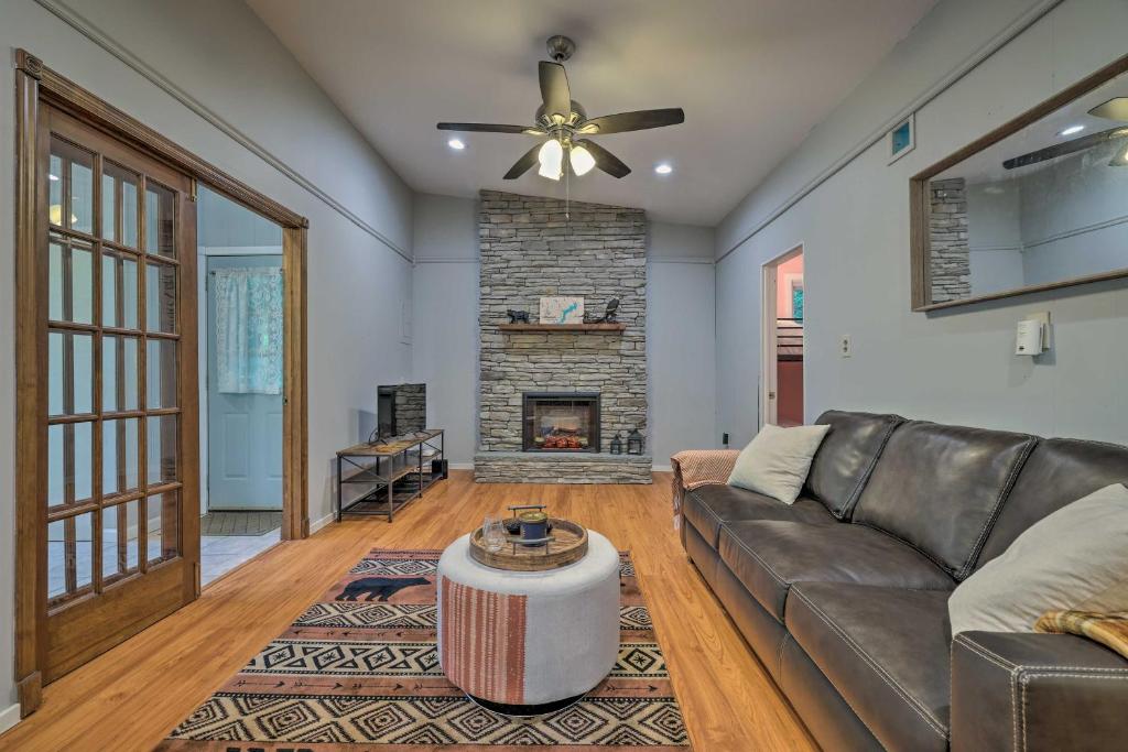 a living room with a couch and a fireplace at 22 Mi to Ski Big Bear! Lake Wallenpaupack Getaway in Greentown