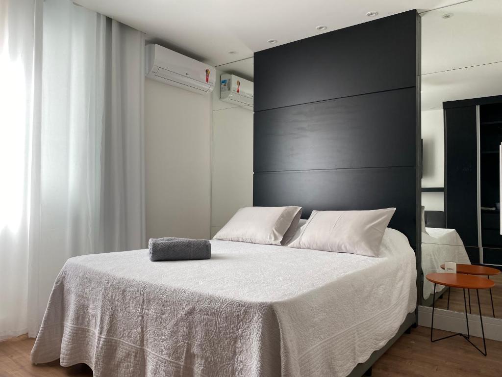 a bedroom with a large bed with a black headboard at prudente 304 in Rio de Janeiro