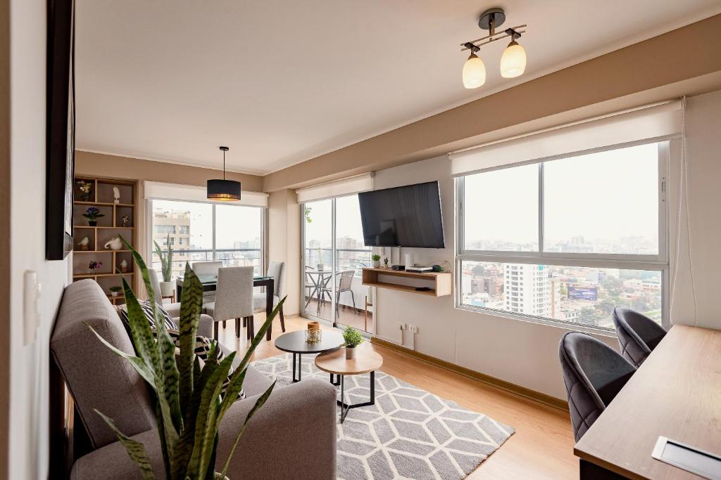 a living room with a couch and a table at ALU Apartments - Limit with Miraflores Panoramic City View in Lima