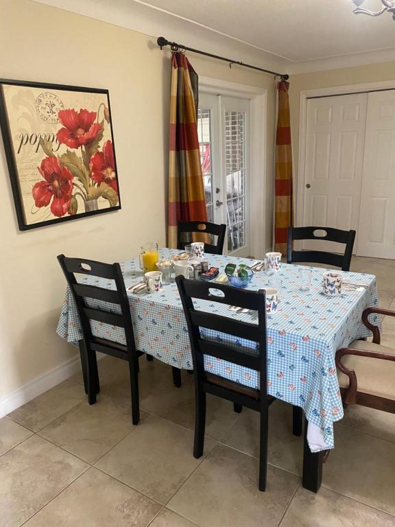 a dining room table with a blue and white table cloth at Butterfly Manor in Niagara Falls