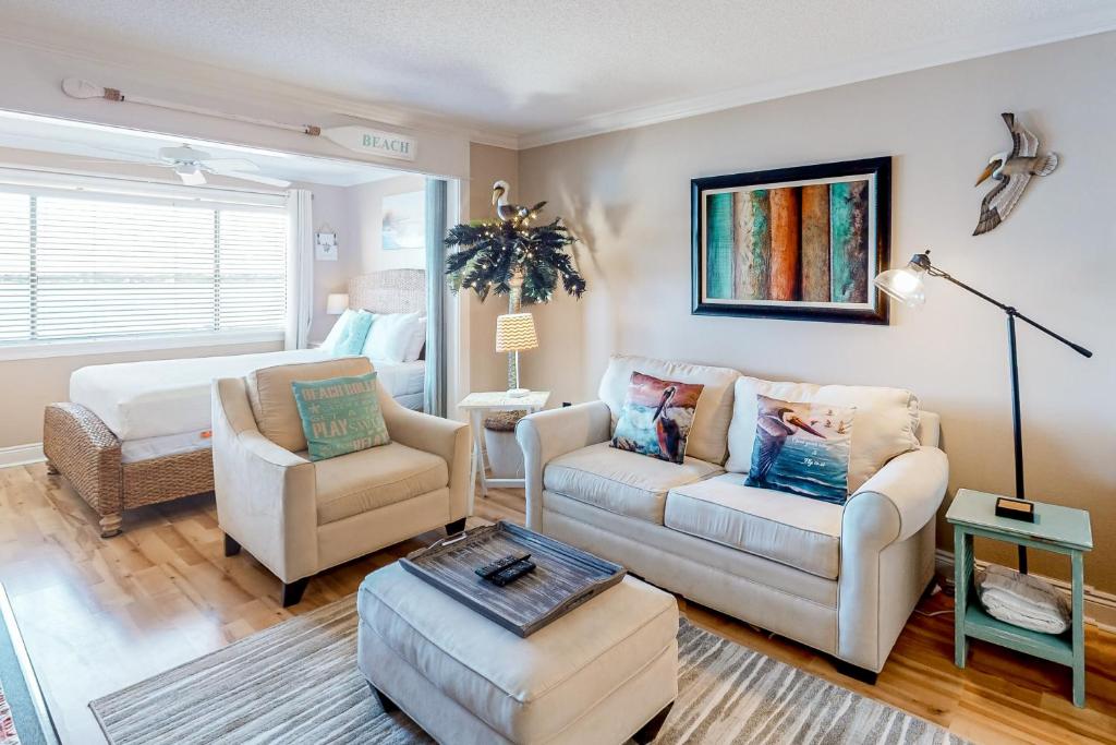 a living room with a couch and chairs and a bed at Sunset Harbor Palms 1-311 in Navarre