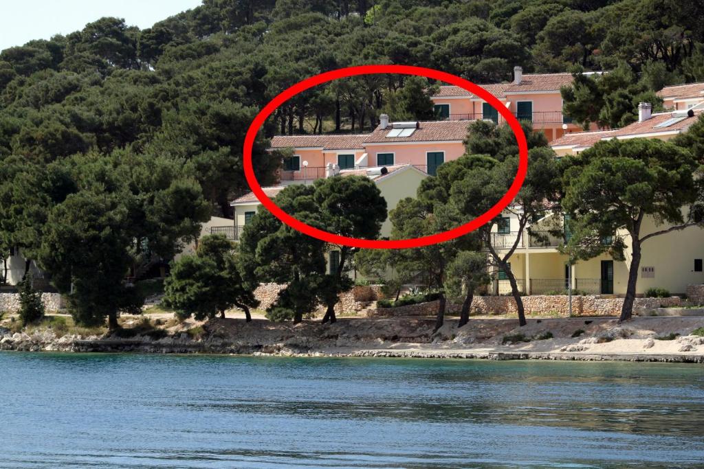 a red circle around a house next to a river at Apartments by the sea Rogoznica - 3200 in Rogoznica