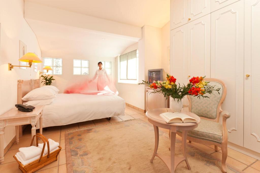a bride is standing on a bed in a bedroom at Hotel Tamaro in Ascona