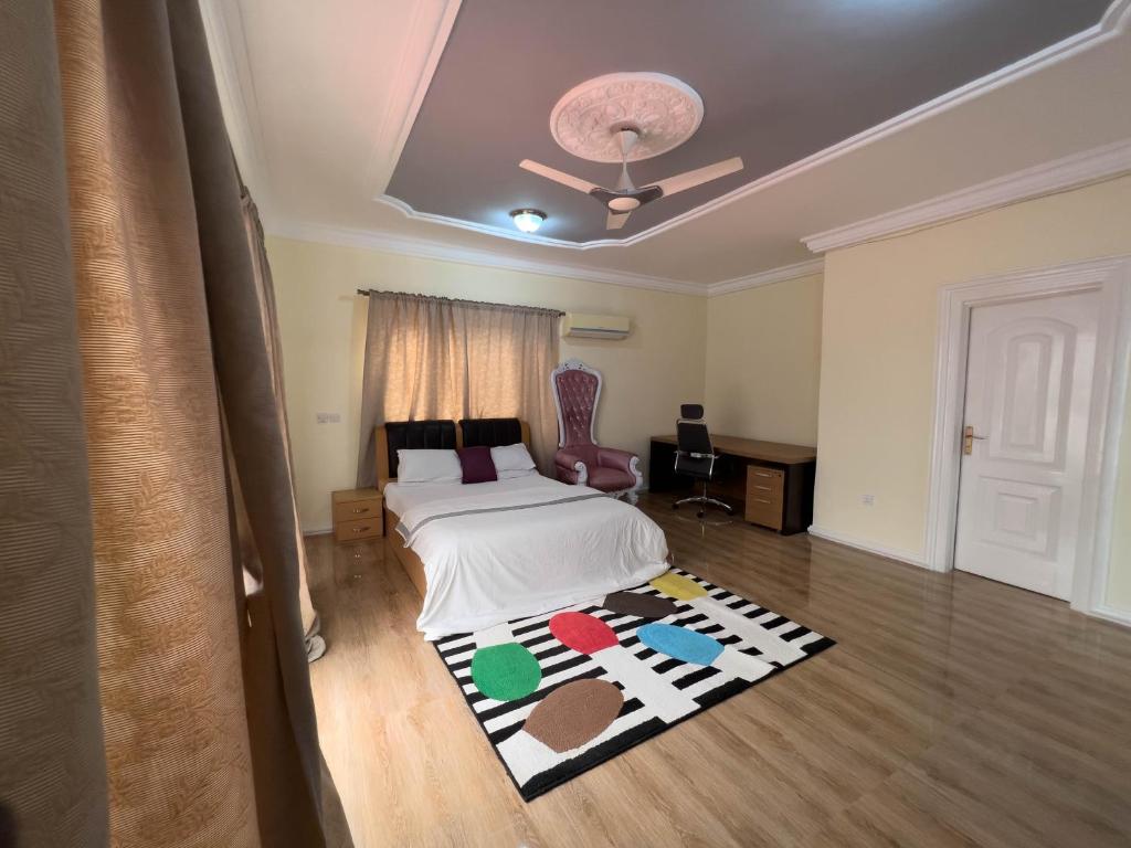 1 dormitorio con cama y alfombra en el suelo en T’s place, en Apenkwa