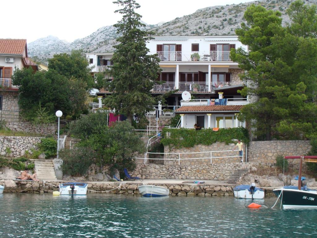 a house on the shore of a body of water at Apartment Buco in Starigrad-Paklenica