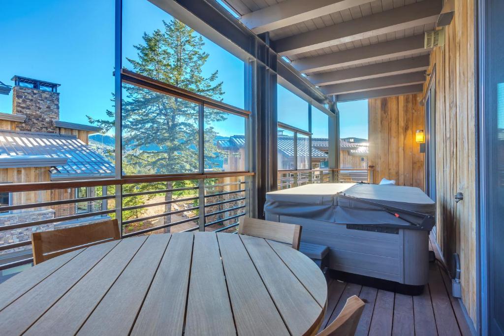 a large balcony with a table and a printer at Premium Three Bedroom in Park City