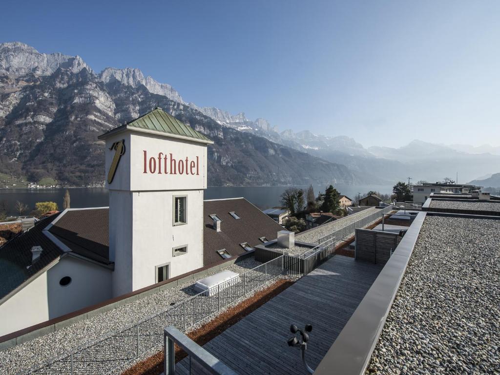 a building with a hotel sign on the side of it at lofthotel Walensee in Murg