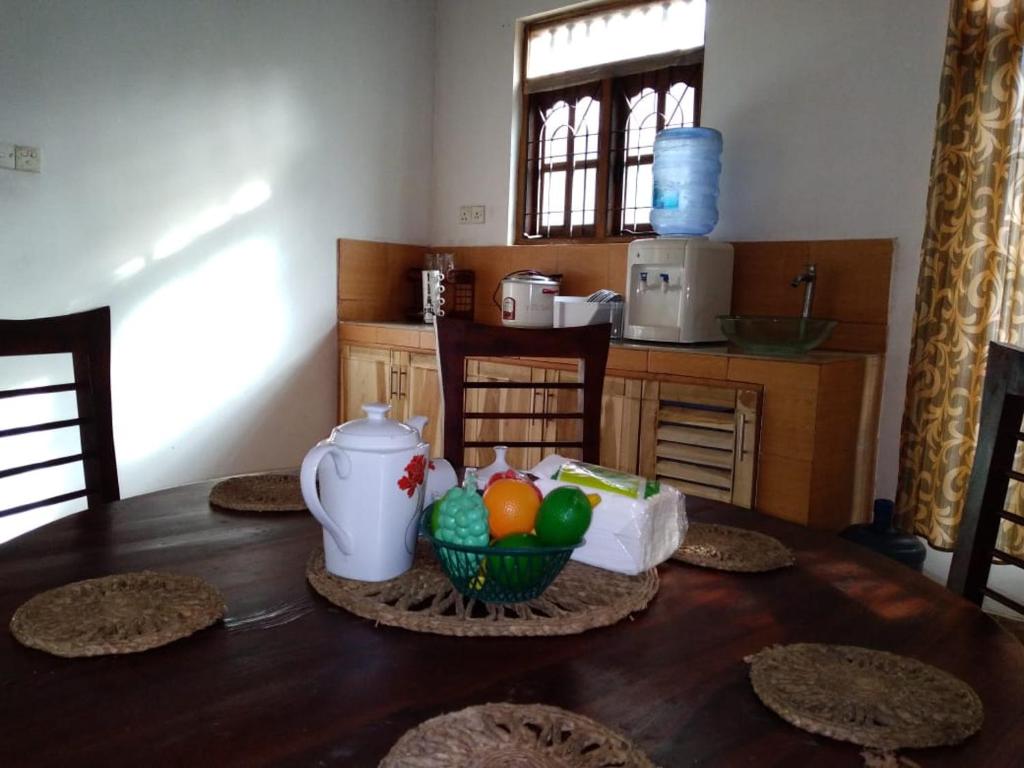 a table with a bowl of eggs in a kitchen at Holiday Home Anuradapura in Anuradhapura