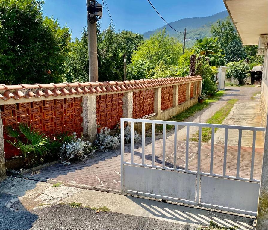 a brick fence with a gate in front of a house at ORTHOPEDIC CENTER NEAR WITH FREE PARKING, Quite and Privately in Lovran