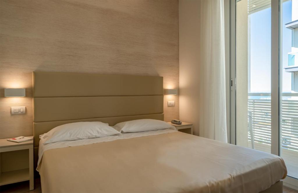 Postel nebo postele na pokoji v ubytování Hotel Bristol