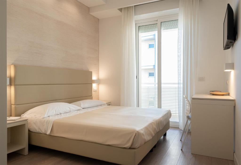 Postel nebo postele na pokoji v ubytování Hotel Bristol
