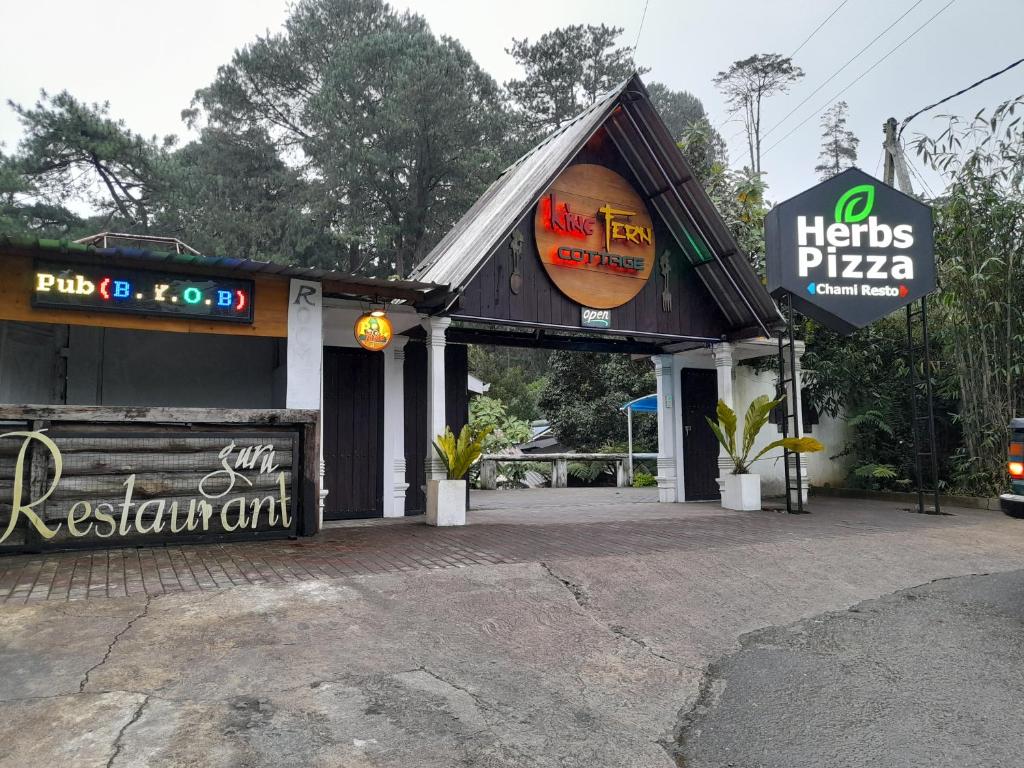 a pizza shop with a sign in front of it at Kingfern in Nuwara Eliya