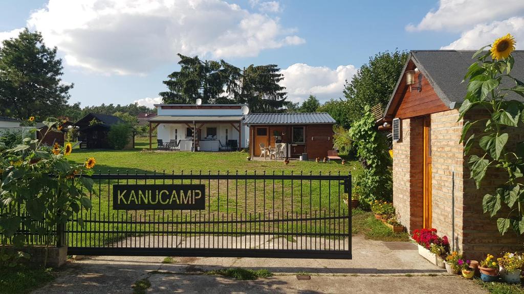 a gate in front of a house with a yard at Kanucamp Altfriesack in Altfriesack