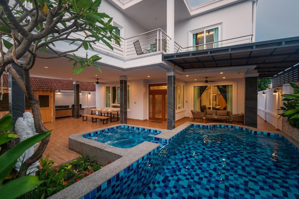 a swimming pool in the middle of a house at Grand Gala Villa in Pattaya South