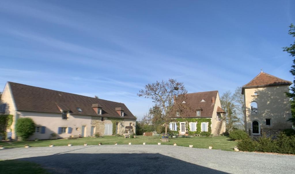 a group of houses with a driveway in front at Gites de Gondieres in Saint-Éloi