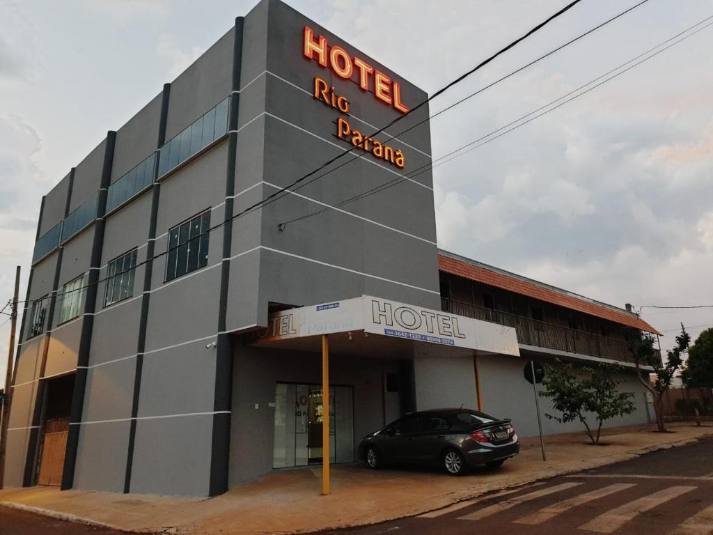 um hotel com um carro estacionado em frente em Hotel Rio Paraná em Guaíra