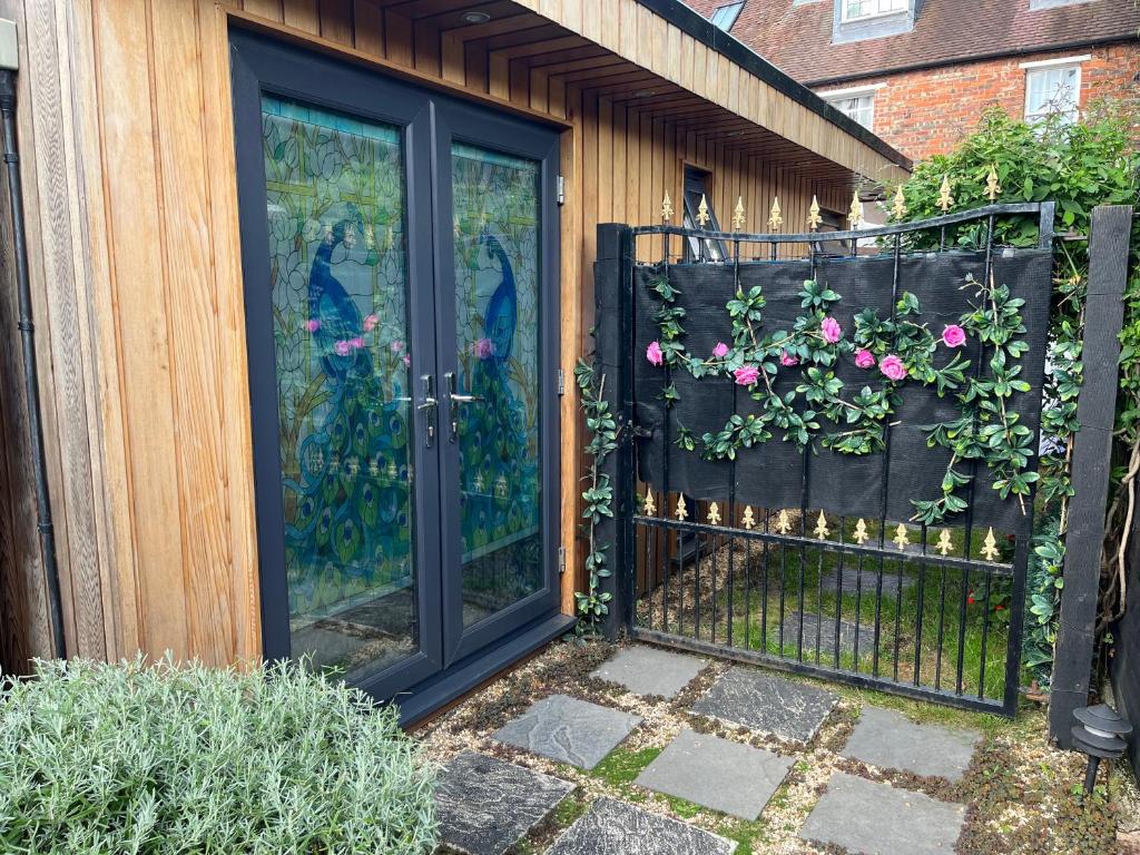 a black door with flowers on a fence at The Citiroom in Chichester