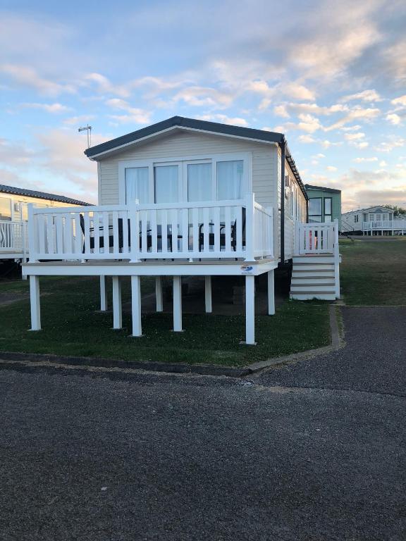 a large white house with a large porch at Crimdon dene holiday park in Hartlepool