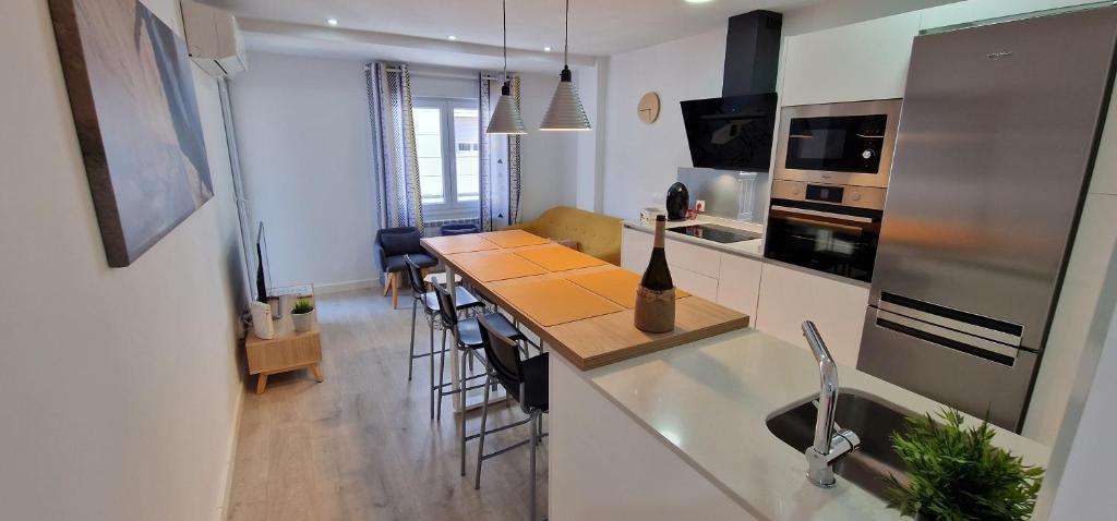 a kitchen with a counter top and a kitchen with a table at Villa Toston City in Salamanca