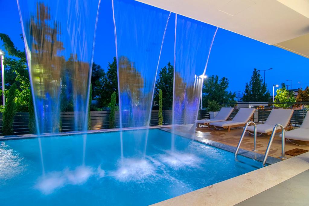 a swimming pool with a fountain in a house at Selin Luxury Residences in Ioannina