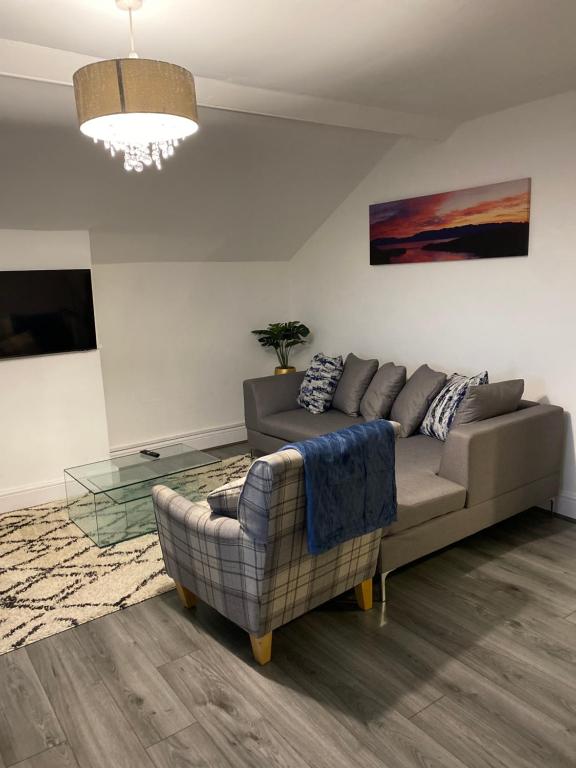 a living room with a couch and a table at Crosby Apartments in Liverpool