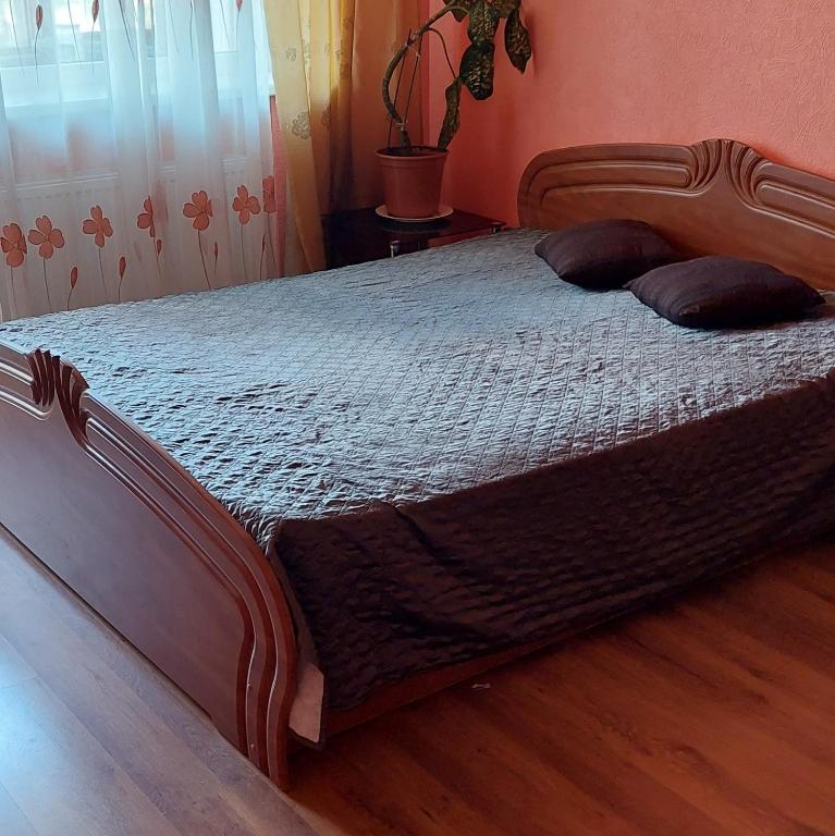 a bedroom with a bed with two pillows on it at 2 room apartment 350 m from sea in Liepāja