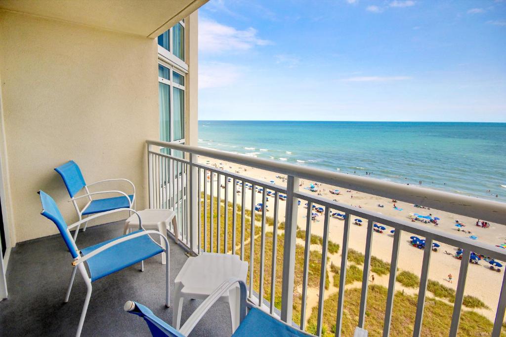 a balcony with chairs and a view of the beach at Bay Watch 1019 in Myrtle Beach