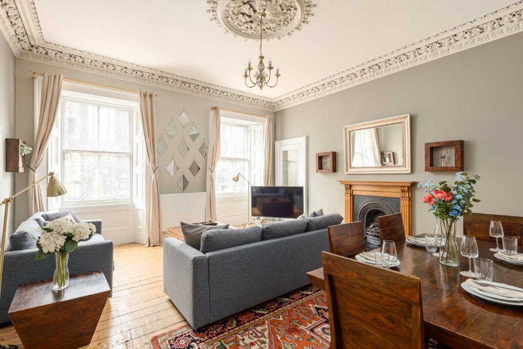a living room with a couch and a table at 2 Bed Old Town Apartment - Next To Castle in Edinburgh