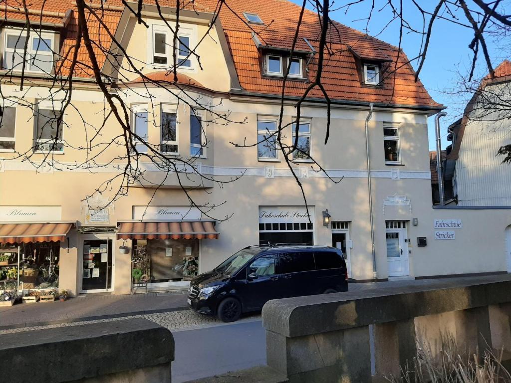 a van parked in front of a building at Ferienwohnung-Stricker-Bad-Sachsa in Bad Sachsa