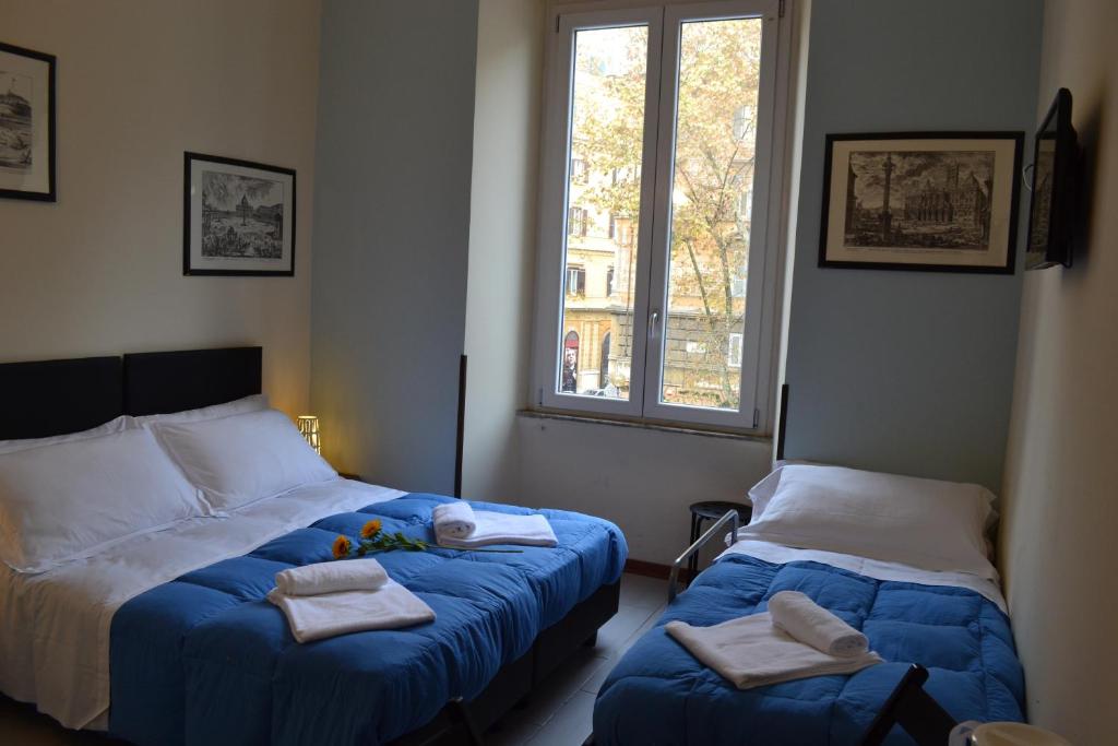 Postel nebo postele na pokoji v ubytování Enjoy Roma