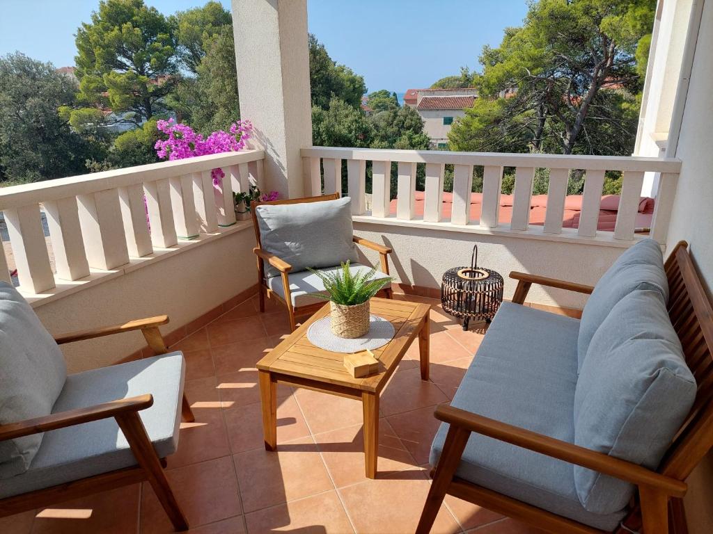 einen Balkon mit Stühlen und einem Tisch auf dem Balkon in der Unterkunft Pinea Sol in Brodarica