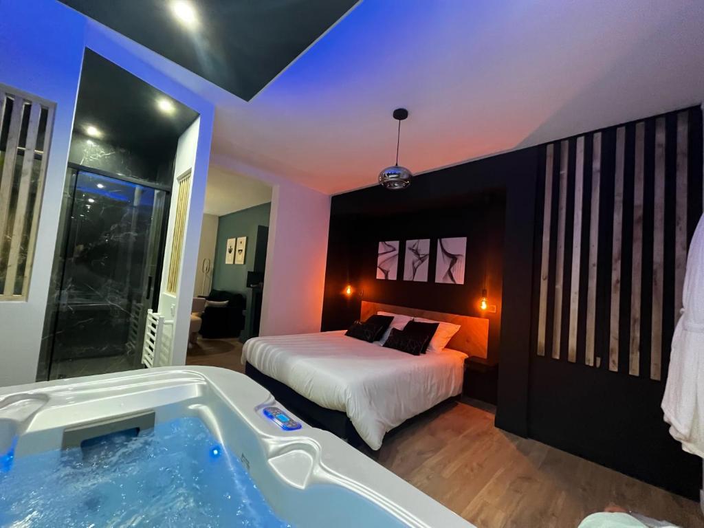 a bedroom with a bed and a bath tub at CK Suite & Spa Reims in Reims