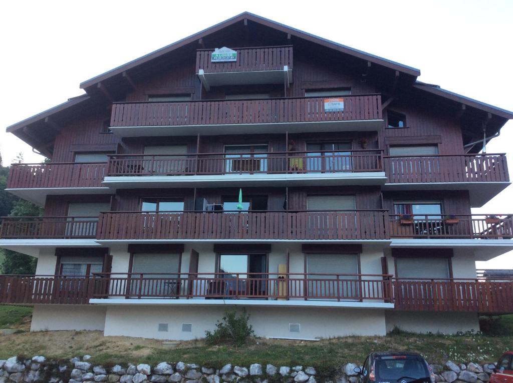 a large building with balconies on the side of it at Le Repaire de Bellevaux aux pieds des pistes Haute Savoie in Bellevaux