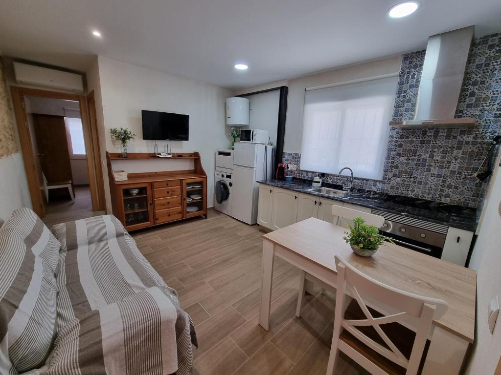 a kitchen with a table and a dining room at Loft Blanco in L'Ametlla de Mar