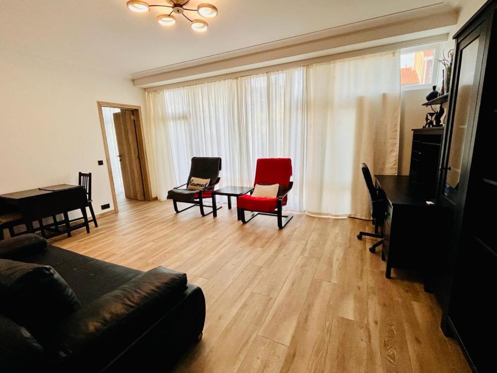 a living room with a couch and chairs and a table at Residential area - quiet place in Brussels