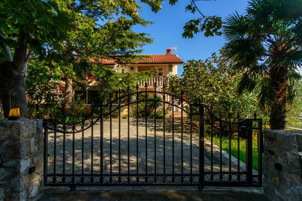 an iron gate in front of a house at Apartment Marko in Kornić